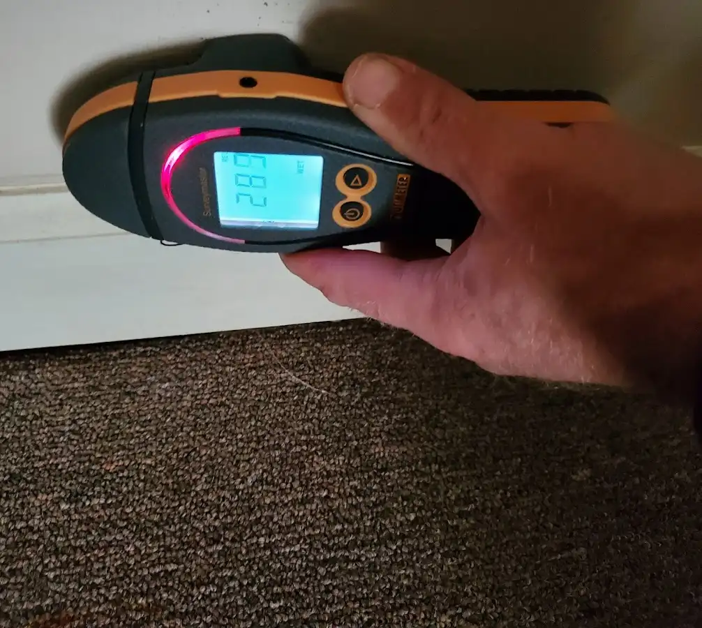 Moisture detection at baseboard during Storm Damage Restoration in Hurricane